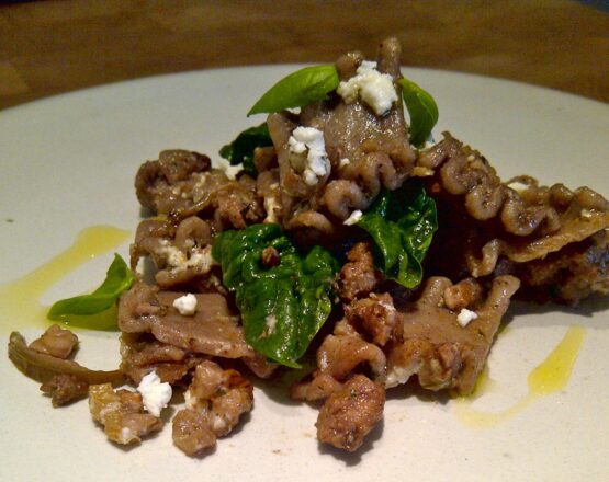 Pasta with sausage, vegetables, feta and herbs