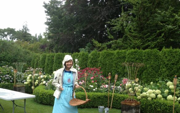 Frances cutting flowers in the pouring rain at Bee Cottage