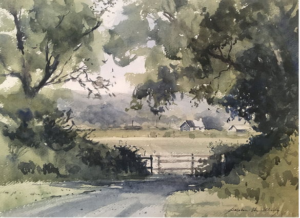 country road and gate looking onto pasture and distant barns in the Cotswolds